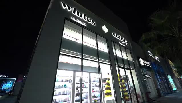 WHITES storefront at night